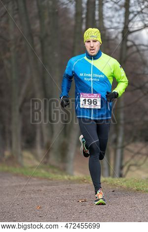 Ostrava, Czechia - 02.04.2023: Vertical Shot Of Male Runners In Sportswear Competing During Winter A