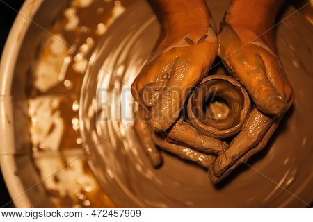 Close Up On Skillful Hands Sculpting Pottery Jar On Potter Wheel