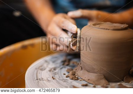 Close Up On Skillful Hands Sculpting Pottery Jar On Potter Wheel