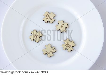 Set Of Puzzles With Five Biologically Important Elements For Humans With Brown Lettering On A White 