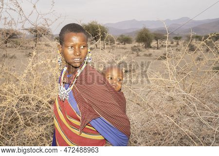Karatu, Tanzania - October 16th, 2022: A Portrait Of A Masai Woman In Traditional Clothes And Jewelr