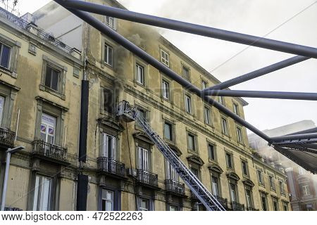 Editorial, Domestic Apartment Fire With Smoke Billowing From Window. Garibaldi Square, Naples, Italy
