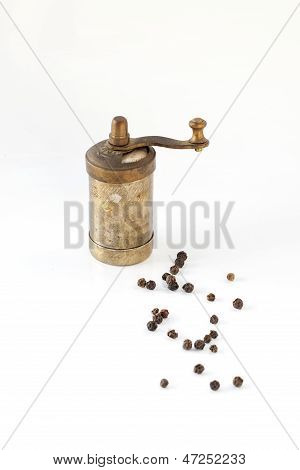 Vintage bronze pepper mill isolated on white background