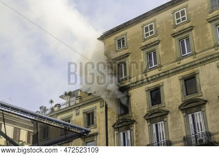 Editorial, Domestic Apartment Fire With Smoke Billowing From Window. Garibaldi Square, Naples, Italy