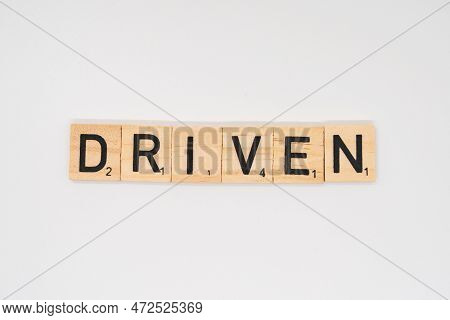 Wolverhampton, England - March 12 2023: Wooden Title Spelling The Word Driven Isolated On A White Ba