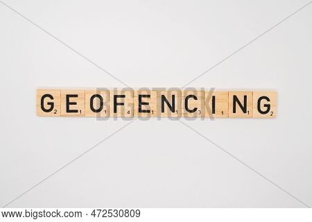 Wolverhampton, England - March 12 2023: Wooden Title Spelling The Word Geofencing Isolated On A Whit