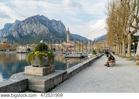 Lecco, Italy - April 2022: Tourists And Locals Spending Sunny Spring Day In Lecco, A Town On The Sho