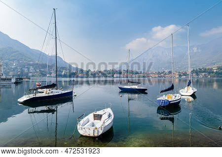 Colourful Yachts Docked At Marina Of Lecco Town On Spring Day. Picturesque Waterfront Of Lecco Locat