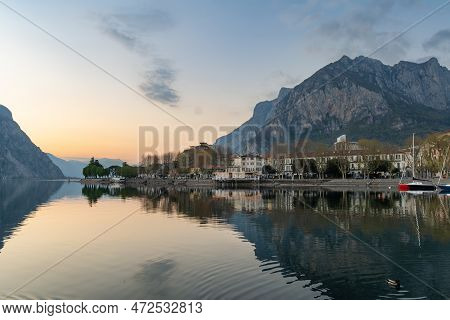 Sunny Cityscape Of Lecco Town On Spring Day. Picturesque Waterfront Of Lecco Town Located Between Fa