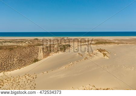 Aerial View Of Tropical Sandy Beach And Blue Sea. Paoay Sand Dunes, Ilocos Norte, Philippines.