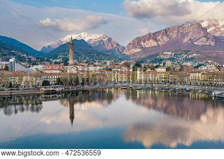 Cloudy Aerial Cityscape Of Lecco Town On Spring Evening. Picturesque Waterfront Of Lecco Town Locate
