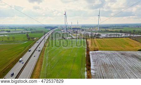 View From Above On The German Motorway A7 With Some Windmills For Renewable Electricity Under Constr