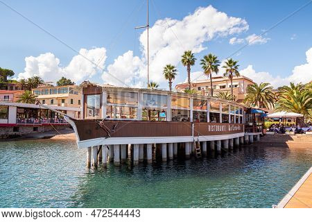 Porto Azzurro Island Of Elba Italy - 19 September 2021 Cityscape Of Harbor Of Porto Azzurro