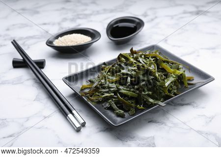 Fresh Laminaria (kelp) Seaweed Served On White Marble Table