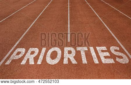 Priorties Written On Running Track, New Concept On Running Track Text In White Colour