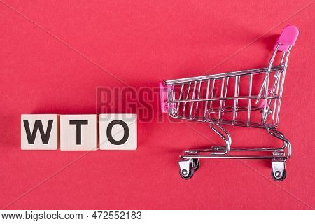 Wto - World Trade Organization Word Writtenwooden Cubes With Shopping Trolley, Business Concept.