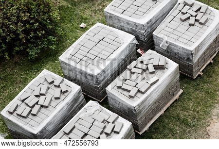 Pallets With Stacked Gray Paving Slabs. Stack Of Paving Slabs In Warehouse, Road Repair Or Finished 