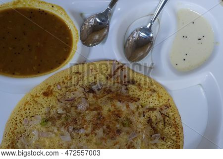 Uttapam Is Served With Chutney On White Plate, Indian Vegetable Dish.