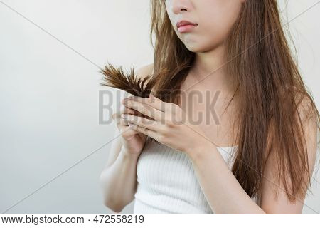 Damaged Hair, Frustrated Asian Young Woman, Girl Hand In Holding Splitting Ends, Messy Unbrushed Dry