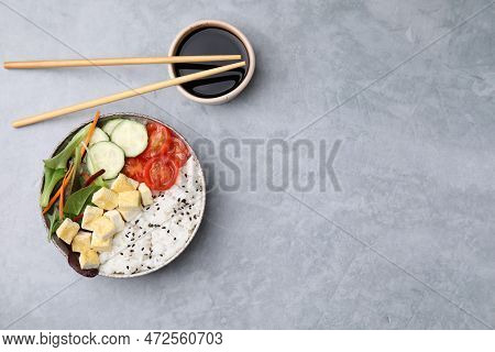 Delicious Poke Bowl With Vegetables, Tofu And Mesclun Served On Light Grey Table, Flat Lay. Space Fo