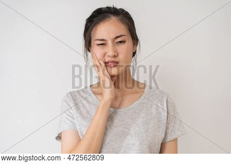 Closing Eyes Asian Young Woman Touching Cheek, Face Expression From Toothache, Tooth Decay Or Sensit