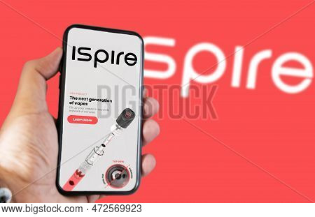 New York, Usa, March 2023: Hand Holding A Phone With Ispire Website On The Screen. Financial Investm