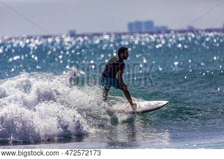 Playa Del Carmen, Mexico; March 13, 2023: Surfer Balancing His Board On The Crest Of An Ocean Wave,