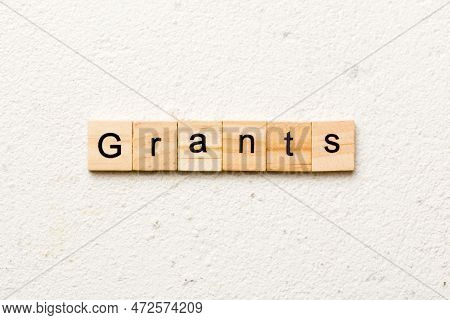 Grants Word Written On Wood Block. Grants Text On Table, Concept.
