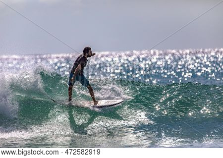 Playa Del Carmen, Mexico; March 13, 2023: Man Surfing The Waves Of The Caribbean Sea In The Middle O