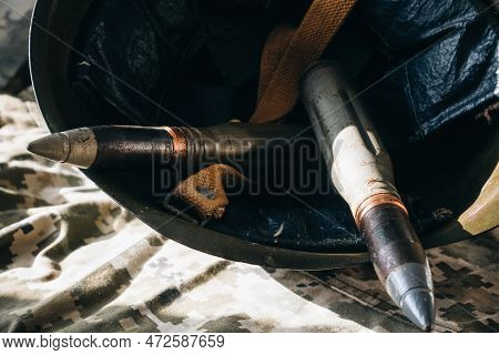 Bullets And Helmet On Khaki Camouflage Background. Lend-lease And Army Concept. Sales Of Weapons And