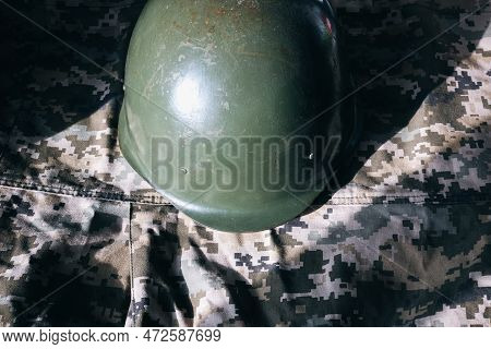 Military Helmet On Khaki Camouflage Background. Lend-lease And Army Concept. Sales Of Weapons And Am