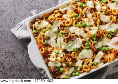 Italian Pasta Anelli Baked With Tomatoes, Cheese, Minced Meat, Green Peas, Carrots And Celery Close-