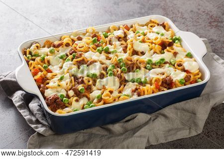 Homemade Anelli Gratin With Cheese, Ground Beef, Vegetables Close-up In A Baking Dish On The Table. 