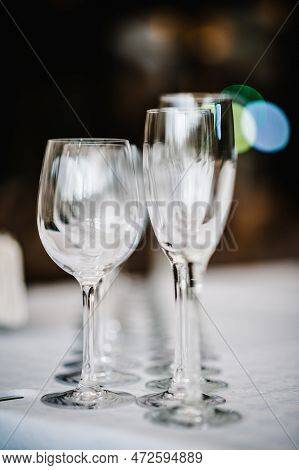 Empty Glass For Wine And Champagne Stand On White Table. Close Up. Empty Glasses For Elite Drinks St