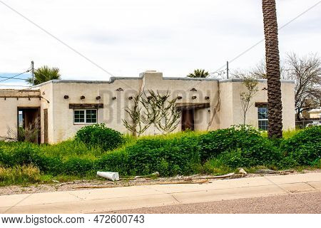 Abandoned Spanish Style House With Overgrown Weeds
