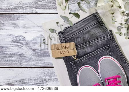 Sustainable Still Life With Jeans With Label Second Hand, Textile Bag And Sneakers. Second Hand Clot