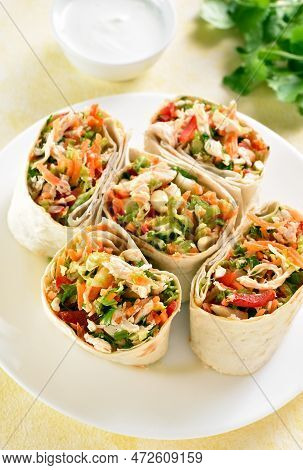 Tortilla Wraps With Chicken And Fresh Vegetables On Plate Over Light Background. Close Up View