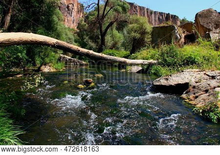 A Log Across A Fast Mountain River On The Background Of Mighty Rocks In The Ihlara Valley, Cappadoci