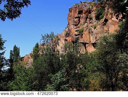 Dense Green Forest And Overhanging Rock In The Ihlara Valley In Central Anatolia, Cappadocia, Turkey