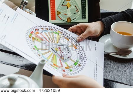 Tver, Russia - February 12, 2023: A Woman At The Table Is Studying A Rave Mandala By Human Design. R