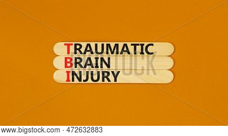 Tbi Traumatic Brain Injury Symbol. Concept Words Tbi Traumatic Brain Injury On Wooden Stick On A Bea