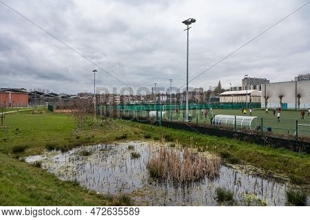 Forest,  Brussels Capital Region, Belgium, March 4, 2023 - Water Pond And Soccer Field At The Bempt 