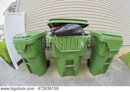 Horizontal Fisheye Lens View Of An Overstuffed Trash Bin.