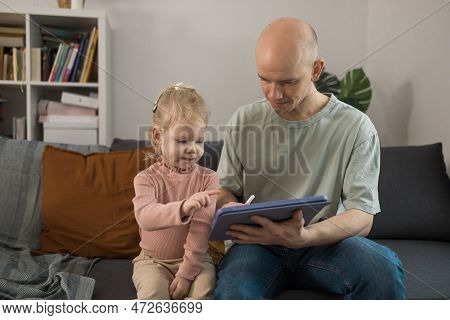 People With Cochlear Implant System. Kid Study To Hear With Her Father, Learning With Video On Table
