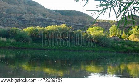 Sunrise By The River In The Badlands
