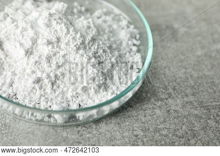 Petri Dish With Calcium Carbonate Powder On Light Grey Table, Closeup