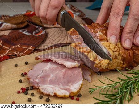 A Piece Of Juicy And Tasty Bacon Is Cut With A Kitchen Knife Into Appetizing Pieces. Close-up Of Fem