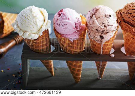 Variety Of Ice Cream Scoops In Cones With Chocolate, Vanilla And Strawberry