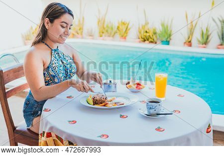 Woman On Vacation Having Breakfast Near Swimming Pool. Breakfast Concept Near Swimming Pool, Smiling