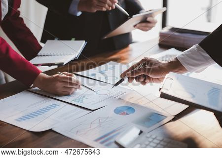 Group Business People Are Reviewing Monthly Sales Documents Analysis And Marketing Plans For More Sa